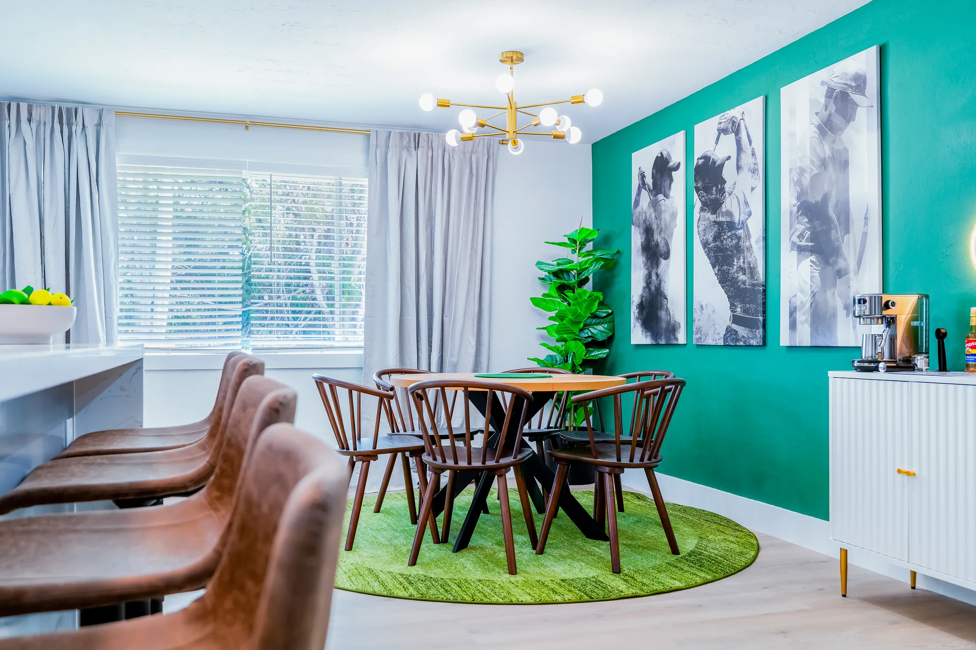 Eclectic dining room with emerald feature wall